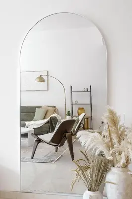 a mirror in a room with a chair and a bed at DAYF-ALI City's Heart Chic 1 BR Huge Terrace and Great Access in Dubai