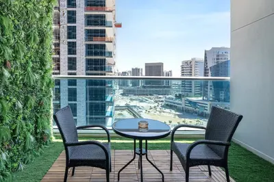 a patio with a table and chairs on a balcony at Studio Apartment featuring Alexa in Elite Residence - Allsopp & Allsopp in Dubai