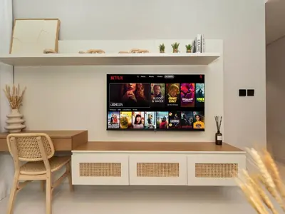 a living room with a tv on a wall at Cozy One Bedroom on the Beach in Dubai Harbour - Prestige Retreats in Dubai
