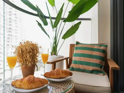 a table with two plates of pastries and two glasses of orange juice at Cozy One Bedroom on the Beach in Dubai Harbour - Prestige Retreats in Dubai