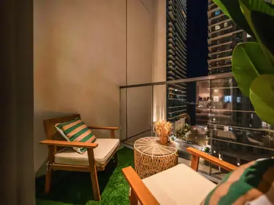 a balcony with a view of a city at night at Cozy One Bedroom on the Beach in Dubai Harbour - Prestige Retreats in Dubai