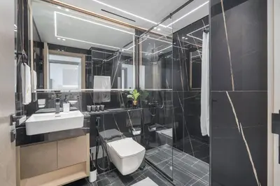 a bathroom with a toilet and a sink and a shower at Vogue JVC Binghatti Corner near Circle Mall, One Bedroom Apartment with Balcony and City View, Access to all Amenities in Dubai