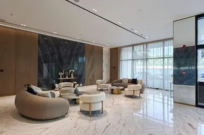 a large lobby with couches and tables and chairs at Vogue JVC Binghatti Corner near Circle Mall, One Bedroom Apartment with Balcony and City View, Access to all Amenities in Dubai