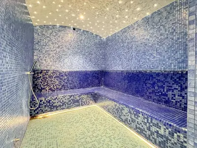 a blue tiled bathroom with a tub in a room at GuestReady - Business Bay delight in Dubai