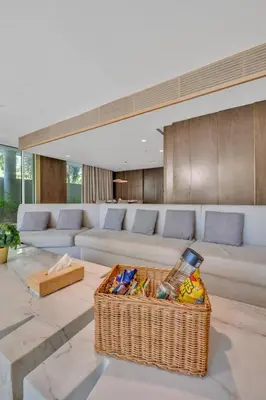 a living room with a couch and a basket at Palm Haven Luxe 3 Bed Townhouse with Private Pool in Dubai
