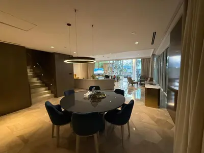 a dining room and kitchen with a table and chairs at Palm Haven Luxe 3 Bed Townhouse with Private Pool in Dubai