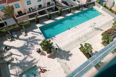 an overhead view of a swimming pool in a building at Cozy Boho Retreat One Bedroom Sanctuary in Dubai