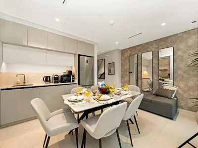 a kitchen and dining room with a table and chairs at Designer Large 1 BR with Private Beach Infinity pool in Dubai Harbour in Dubai