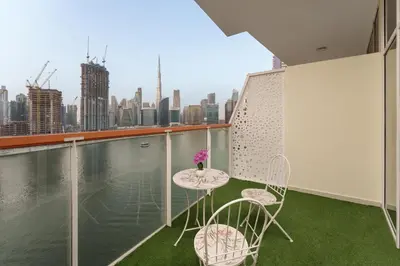 a balcony with a table and chairs and a view of the city at Business Bay Gem , Burj Khalifa View in Dubai