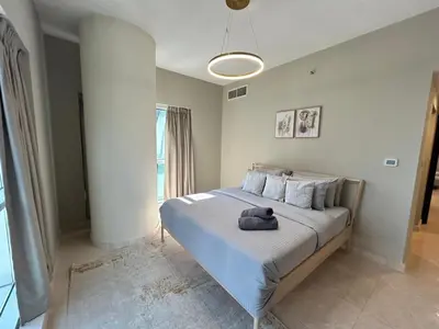 a bedroom with a bed with a stuffed animal on it at 1BR Apt in Business bay close to canal and Dubai mall! in Dubai