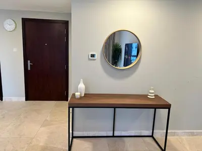 a mirror on a wall next to a table at 1BR Apt in Business bay close to canal and Dubai mall! in Dubai