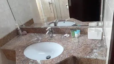 a bathroom counter with a sink and a mirror at 1BR Apt in Business bay close to canal and Dubai mall! in Dubai