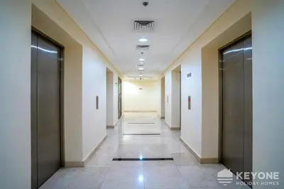 a corridor of an office building with doors and tile floors at Contemporary One Bedroom with Full Marina View in Dubai