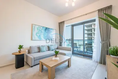 a living room with a couch and a table at Charming 1BR in Orchid Residence, Al Barsha South by Deluxe Holiday Homes in Dubai