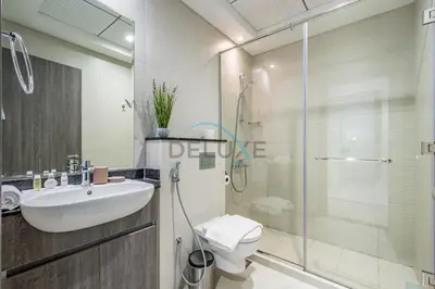 a bathroom with a toilet and a sink and a shower at Charming 1BR in Orchid Residence, Al Barsha South by Deluxe Holiday Homes in Dubai