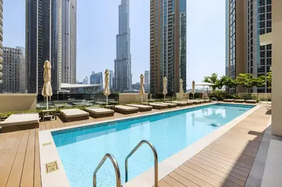 a swimming pool on the roof of a building with tall buildings at 1BR Act One Act Two T2 City View Downtown in Dubai