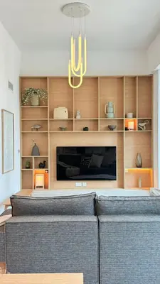 a living room with a couch and a television at DAYF-LFT 2 BR in the heart of Downtown walking distance to Burj Khalifa Park in Dubai
