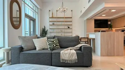 a living room with a couch and a kitchen at DAYF-LFT 2 BR in the heart of Downtown walking distance to Burj Khalifa Park in Dubai