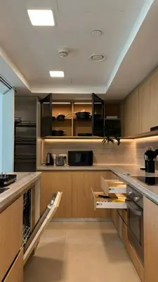 a large kitchen with wooden cabinets and counters at DAYF-LFT 2 BR in the heart of Downtown walking distance to Burj Khalifa Park in Dubai