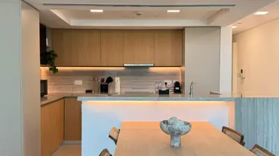 a dining room with a table and a kitchen at DAYF-LFT 2 BR in the heart of Downtown walking distance to Burj Khalifa Park in Dubai