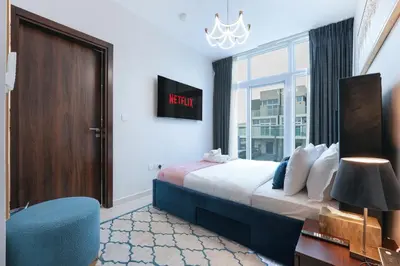 a hotel room with a bed and a window at Luxurious 3BDR Serenity Awaits in Damac Hills 2 in Dubai