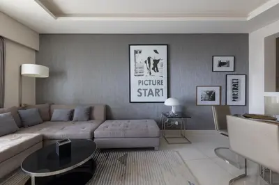a living room with a couch and a table at Cozy 1BR with balcony great view, Damac Towers in Dubai