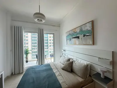 a bedroom with a bed and a large window at Urban Cozy 1BR apartment with Canal view - Free parking in Dubai