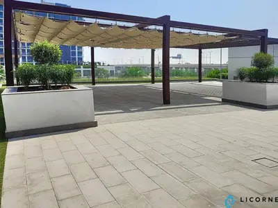 a pavilion with two potted plants on a patio at Modern Contemporary Studio in Azizi Riviera in Dubai
