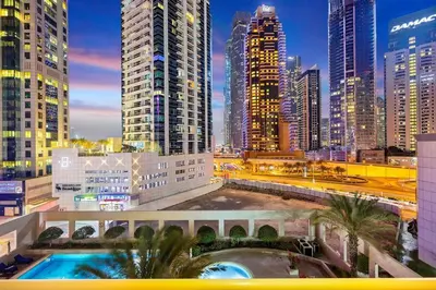 a view of a city at night with tall buildings at FIRST CLASS 1BR Charming Marina Escape in Dubai