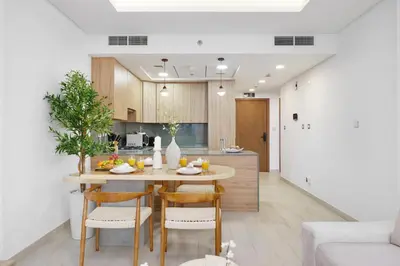 a kitchen and dining room with a table and chairs at Dejaview Stays Luxury Apartment with Private Terrace, Burj & Sea View in Dubai