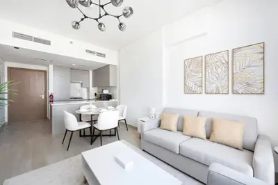 a living room with a couch and a table at Cozy 2-Bedroom Apartment in Fawad Azizi Residence in Dubai