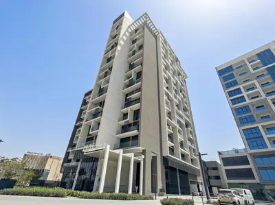 a tall building with a car parked in front of it at Modern Studio Near To Park in Dubai