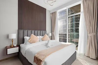 a bedroom with a large bed and a large window at ALiving Elegant 1BR I Near Burj Khalifa & Dubai Mall I Missoni Tower- 607 in Dubai