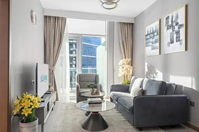 a living room with a couch and a table at ALiving Elegant 1BR I Near Burj Khalifa & Dubai Mall I Missoni Tower- 607 in Dubai