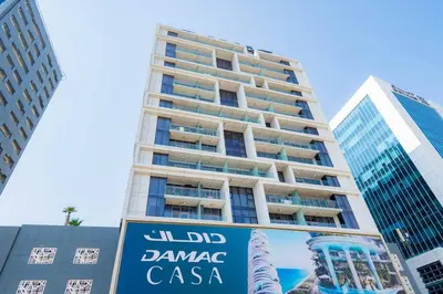 a tall building with a sign in front of it at Cozy Studio Business Bay in Dubai