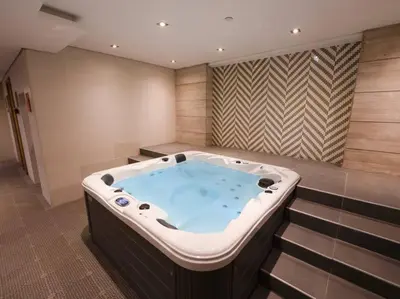 a jacuzzi tub in the middle of a room at Cozy Studio Business Bay in Dubai