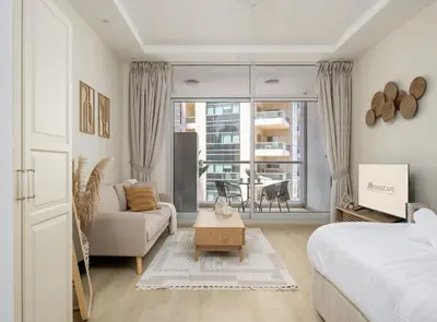 a living room with a bed and a couch at Modern studio near the beach in Dubai