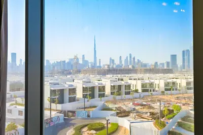 a view of a city skyline from a window at Stylish 1BR by the Lagoon in District One Meydan in Dubai