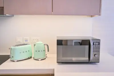 a kitchen with a toaster and a microwave on a counter at Luxury 1-BR with Stunning Views in Palm Tower by Luxe Shortlet in Dubai