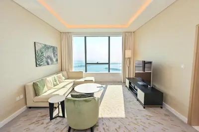 a living room with a couch and a table at Luxury 1-BR with Stunning Views in Palm Tower by Luxe Shortlet in Dubai