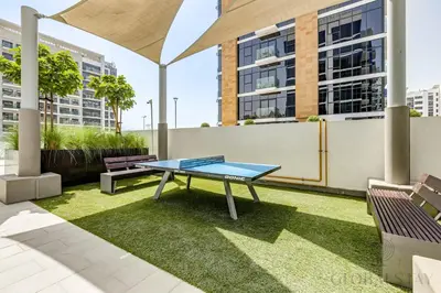 a ping pong table sitting on top of a lawn at GLOBALSTAY Azizi Riviera 45 in Dubai