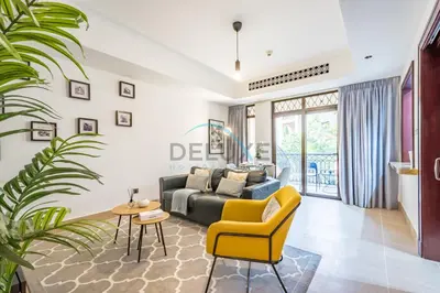 a living room with a couch and a yellow chair at Appealing 1BR Apartment at Miska 2 Old Town, Downtown Dubai by Deluxe Holiday Homes in Dubai