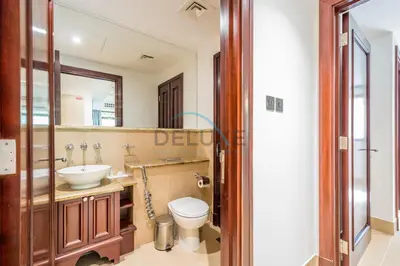 a bathroom with a sink and a toilet and a mirror at Appealing 1BR Apartment at Miska 2 Old Town, Downtown Dubai by Deluxe Holiday Homes in Dubai