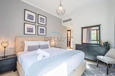 a bedroom with a large white bed and a chair at Appealing 1BR Apartment at Miska 2 Old Town, Downtown Dubai by Deluxe Holiday Homes in Dubai