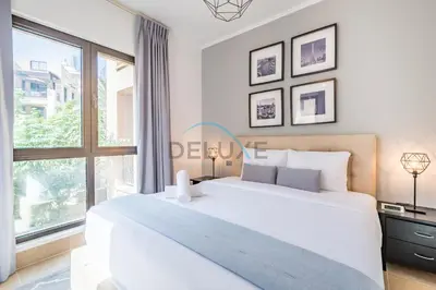 a white bedroom with a large bed and a window at Appealing 1BR Apartment at Miska 2 Old Town, Downtown Dubai by Deluxe Holiday Homes in Dubai