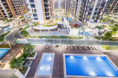 an overhead view of an apartment complex with two pools at Relaxing 1BR Apartment with Built-in Wardrobe & Community View in Azizi Riviera 4, Al Merkadh by Deluxe Holiday Homes in Dubai