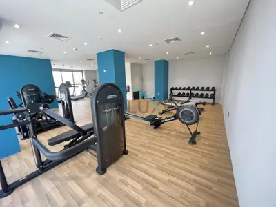 a gym with treadmills and machines in a room at Relaxing 1BR Apartment with Built-in Wardrobe & Community View in Azizi Riviera 4, Al Merkadh by Deluxe Holiday Homes in Dubai