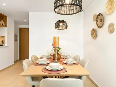 a dining room with a wooden table and chairs at Amazing Stay Experience - Best Burj Khalifa View in Dubai