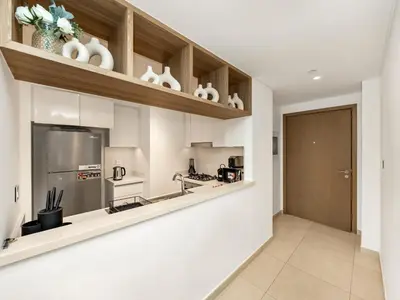 a kitchen with white cabinets and a counter top at Amazing Stay Experience - Best Burj Khalifa View in Dubai
