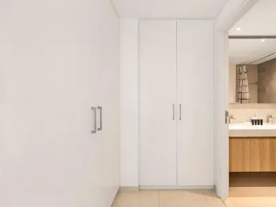 a white bathroom with white cabinets and a sink at Amazing Stay Experience - Best Burj Khalifa View in Dubai